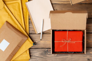 Packing products for delivery on wooden table, top view photo